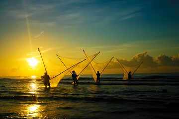 Fishermen repairing nets on a boat trip out to sea in the afternoon July 31, 2016 at the beach of...