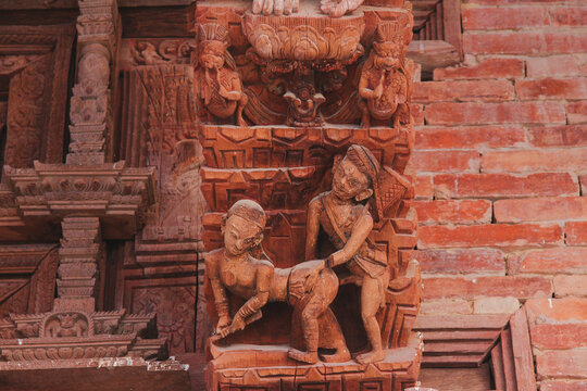 Erotic sensual wooden carvings of hindu gods and goddesses in a temple in Kathmandu, Nepal.