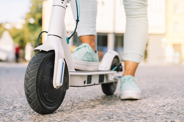 detail of an electric scooter in an urban environment with blurred background - concept of sustainable personal mobility