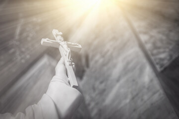 Christian cross appears bright in the background and soft clouds. with the light shining as Love....