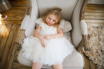 funny little girl does not want to be photographed. naughty, spoiled child. problems at a photo shoot with children.