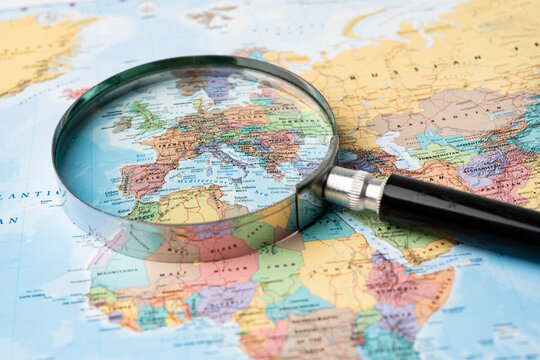 Bangkok, Thailand - August 01, 2020 Europe, Magnifying glass close up with colorful world map