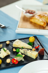Assorted spanish cheese platter on the blue table