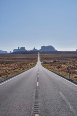 The road leading to the Monument Valley in Utah. Concept of freedom