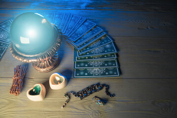 Crystal ball and tarot cards on fortune teller table background
