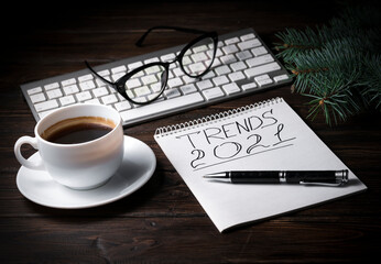 cup coffee and Notebook with Notepad on the table.