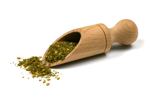 Za'atar (zatar), blend of herbs, sesame seeds and salt in pile on white background.