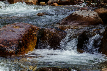 in summer rocky mountain river water silk. mountain river