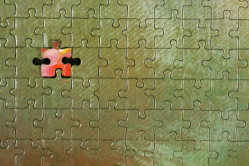 Disassembled puzzle with a last wrong piece impossible to fill