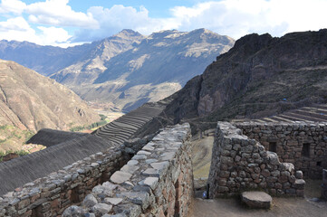 Dramatic landscape view of mountains, terraces and stone ruins in the Sacred Valley of Peru