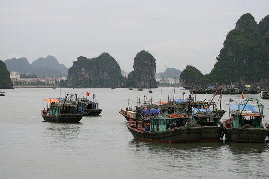 Tourist junks floating among limestone rocks at early morning in Ha Long Bay, South China Sea, Vietnam, Southeast Asia. Five images panorama