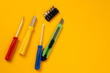 screwdrivers and construction tools on yellow background equipment for repair industry