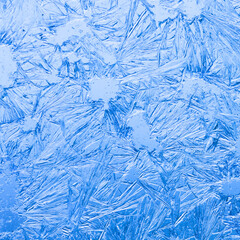 Abstract ice flowers pattern, frosted window macro view background. cold winter weather xmas backdrop.