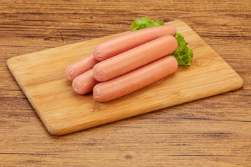 Tasty meat sausages over board