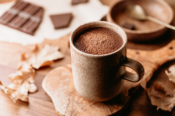 Close-up of hot chocolate on the table. Autumn or winter cozy still life.