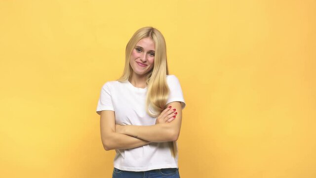 Young caucasian blonde woman who feels confident, crossing arms with determination