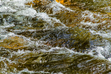 in summer rocky mountain river water silk. mountain river