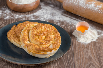 Traditional Turkish Borek or Turkish pastry with minced meat, cheese and spinac on wooden background