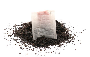 Dry black tea leaves and blank filter bag isolated on white background