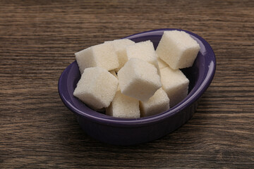 Refined white sugar cubs in the bowl