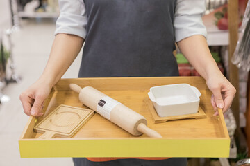 Woman holding a dough rolling pin tools