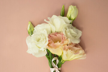 Fototapeta premium A bouquet of delicate fresh flowers on a pink background.