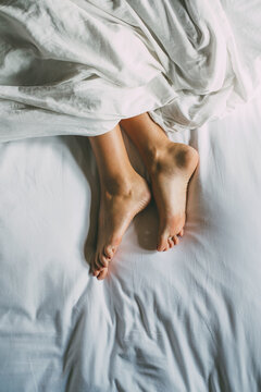 Woman feets in bed.