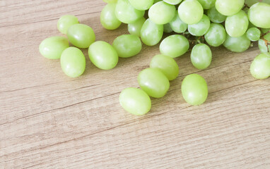 Grapes on a wooden table. Tasty green grapes. 
