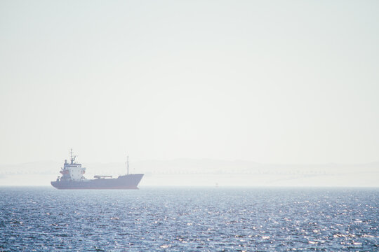 Ship on blue sea with mist and copyspace