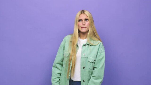 Young caucasian blonde woman confused, feels doubtful and unsure