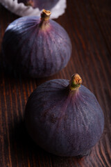 tasty ripe purple  figs fruits  on wooden table. close up