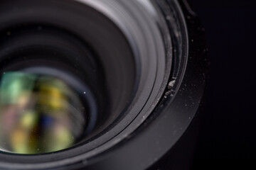 Dusty photo lens on a dark background.