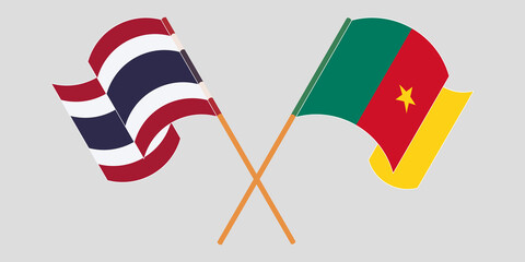 Crossed and waving flags of Cameroon and Thailand