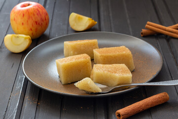 Homemade apple jelly squares with cinnamon on plate. Delicious vegan food