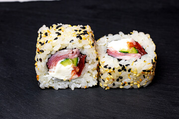 sushi rolls on a black background