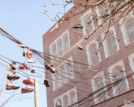 Shoes hang from a tangled telephone wires in NYC