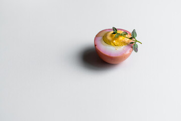 pink boiled eggs with oregano
