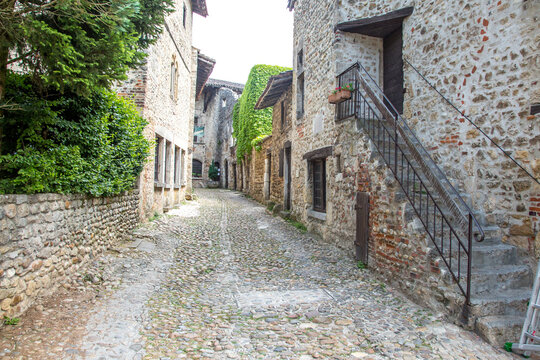 Perouges, France - 6/8/2015: A cobblestone street and stone buildings in  the  historic walled city of Perouges