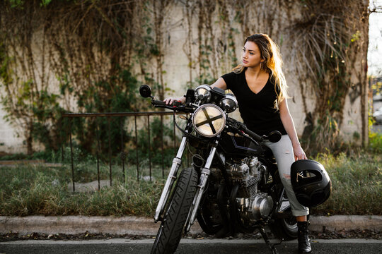 Attractive girl motorcycle rider posing