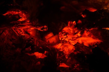 embers burn down in a hardwood fire - 380403575