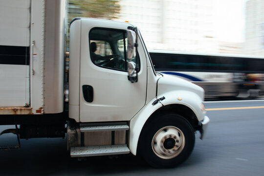 White truck speeding on the road