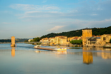 Obraz premium The Place de Saint Colombe bridge across the Rhone River with a commercial river boat in the foreground, in Vienne, France