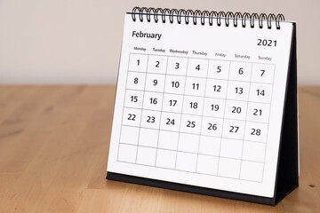Month page: February in 2021 paper calendar on the wooden table