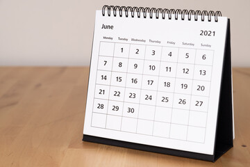 Month page: June in 2021 paper calendar on the wooden table