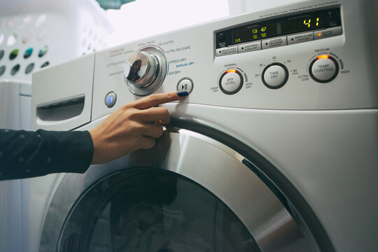 Pajamas: Woman Pushing Start Button On Dryer