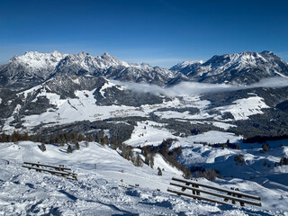 Scenic view Lofer Mountains, Leogang Mountains and ski slopes of Fieberbrunn, Austria against blue sky.