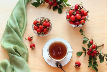 A Cup of rosehip tea with rosehip fruits in cups, close - up, top view-the concept of using medicinal herbs and fruits