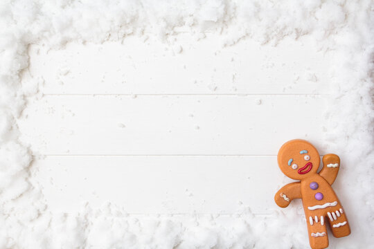 Top view of gingerman on snowy white wooden table. Top view with copy space