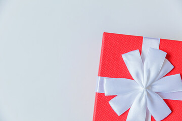 Fototapeta premium Christmas New Year birthday valentine celebration present romantic concept. Simply minimal design red gift box isolated on white background. Flat lay top view copy space.