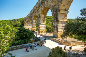 Avignon, France - 6/4/2015:  Tourists visiting Pont du Gard, a Mighty aqueduct bridge rising over 3...